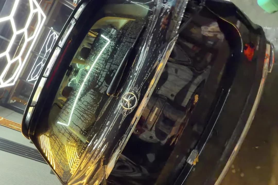 Black car under detailing bay inspection lights at THE CAR O CARE