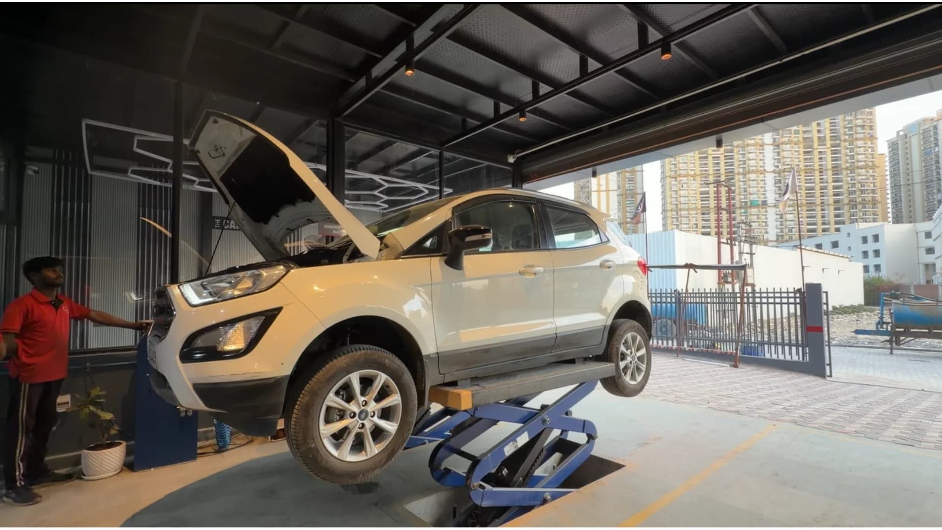 SUV raised on a service lift in the inspection bay